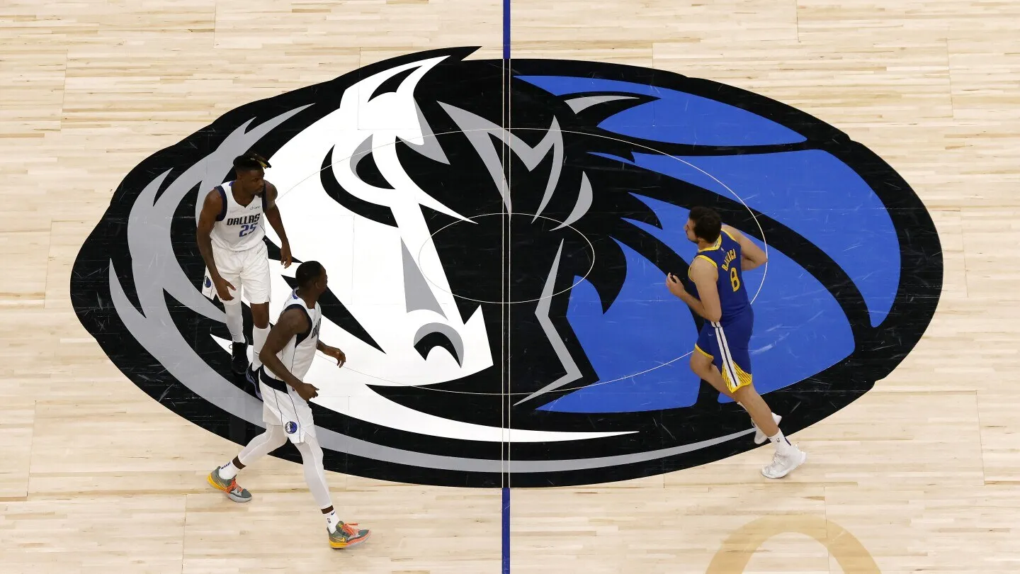 The Dallas Mavericks center-court logo seen from above during a game.