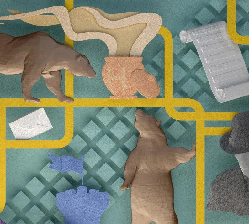 Detail of the papercraft artwork: a bear, a honey pot, an unrolled scroll, a sealed envelope, a castle turret, and a figure in a fedora.